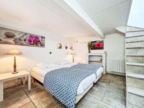 a bedroom with a bed and a desk and a staircase at Apartment L'Abeille d'Or-1 by Interhome in Carnac