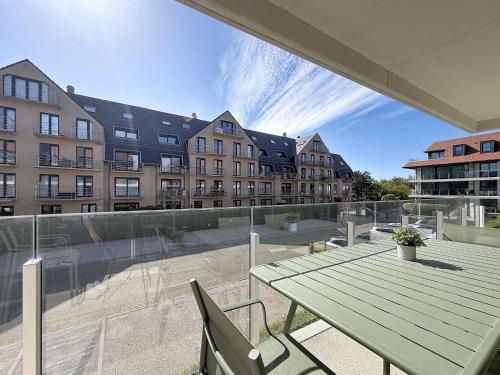 a patio with a table and chairs and buildings at Apartment Wanderlust with garage by Interhome in Mispelburg