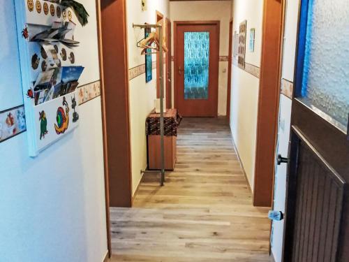 a hallway leading to a room with wooden floors and a door at Apartment Orpington by Interhome in Dreisbach