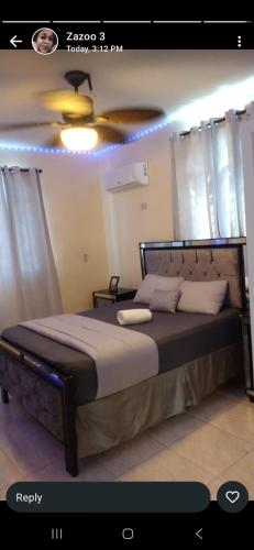 a bedroom with a large bed with a ceiling at Residential Jula in Los Prados