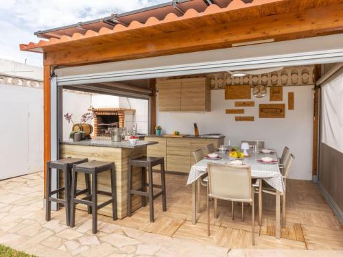 an open kitchen with a table and chairs at Villa Mys by Interhome in Miami Platja
