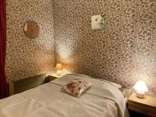 a bedroom with a bed with a pillow on it at Le champ godeau in Chilly