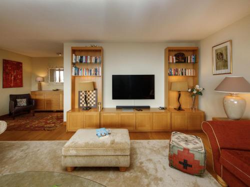 a living room with a flat screen tv on a entertainment center at Apartment Pré Vert 3 by Interhome in Villars-sur-Ollon