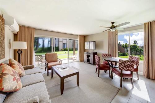 a living room with a couch and a table at Ocean View Condo Pono Kai Resort PF-G102 in Kapaa