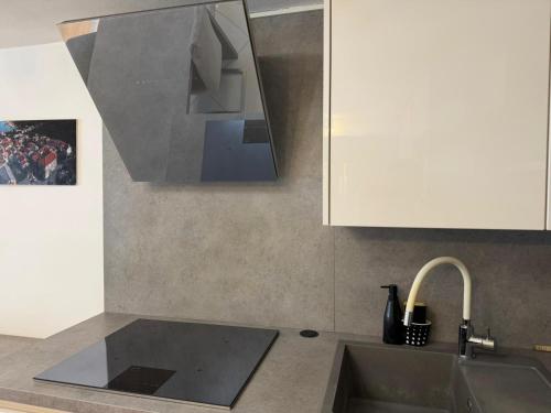 a kitchen with a sink and a white cabinet at Seafront Apartment Bakar in Bakar