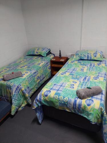 two beds sitting next to each other in a bedroom at Cozy Corner Unit 1 and unit 2 in Bredasdorp