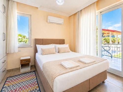 a bedroom with a bed and a large window at Villa Veli in Dalyan