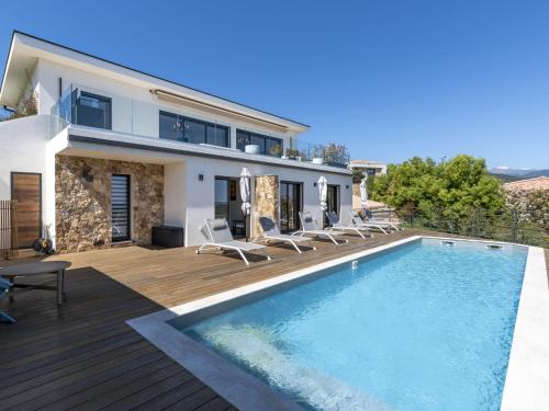 a villa with a swimming pool and a house at Villa Casa Minà by Interhome in Sari Solenzara
