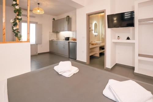 a kitchen with white towels on the floor at Golden View Suites with hot tub in Vóthon