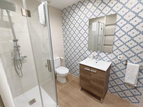 a bathroom with a shower and a toilet and a sink at Ca Na Margalida in Muro