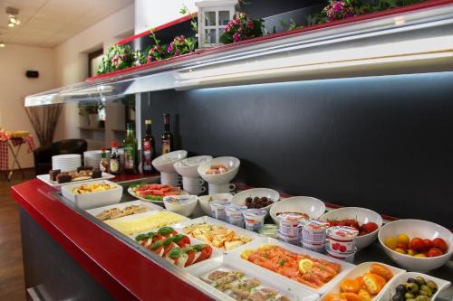 a buffet line with many different types of food at Montana Hotel in Oberasbach