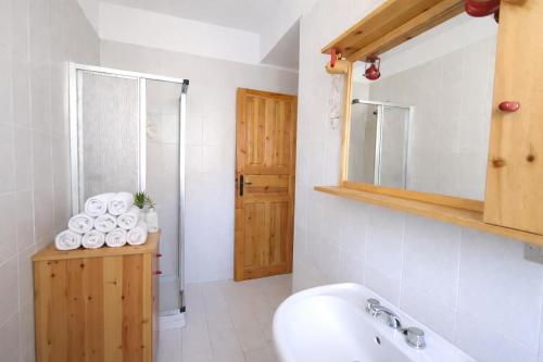 a bathroom with a sink and a shower and a mirror at Appartamento Alta Valle Maira - Nebin in Villaro