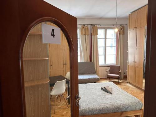 a room with a room with a bed and a mirror at Wrocławska Rooms in Poznań