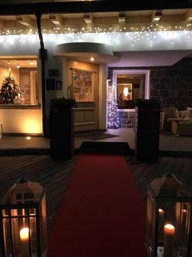 a red carpet on the floor of a room with lights at Ciasa Alpina Relax Hotel in Moena