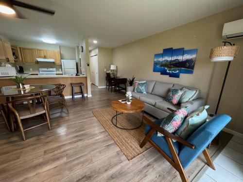 a living room with a couch and a table at 2 Bedroom OceanView Condo Pono Kai Resort E103 in Kapaa