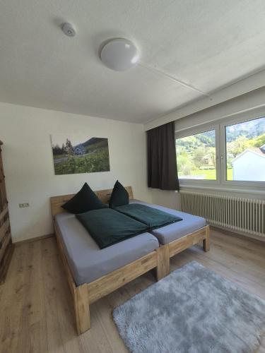 a bedroom with a bed and a large window at Pyhrn Alps Inn "24h Self-Check-in-Hotel" in Spital am Pyhrn