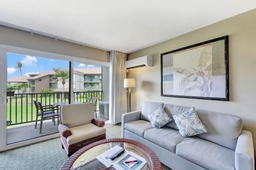 a living room with a couch and a chair at Kauai Serenity Condo Pono Kai Resort E206 in Kapaa
