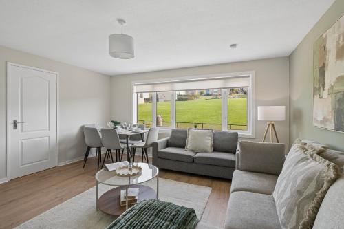 a living room with a couch and a table at Lime Grove House in Dalkeith