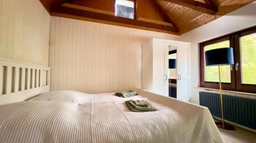 a bedroom with a bed and a tv on the wall at Kleine Auszeit Buchholz in Buchholz in der Nordheide