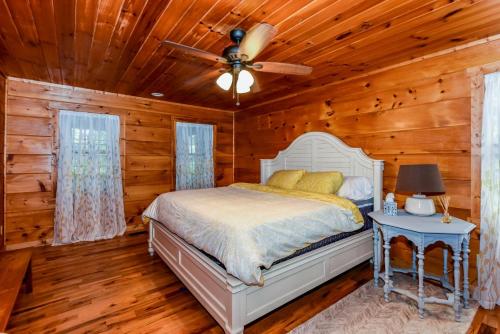 a bedroom with a bed and a ceiling fan at Tree Tops in Townsend