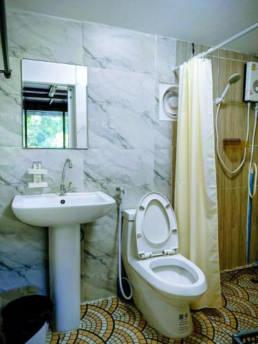 a bathroom with a toilet and a sink and a shower at Lake side villa in Ko Phangan