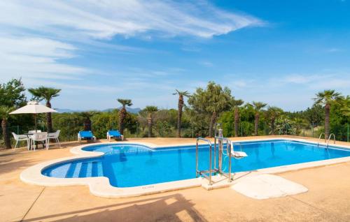 a swimming pool with a table and chairs next to it at Sa Palmaria Dos in Can Picafort