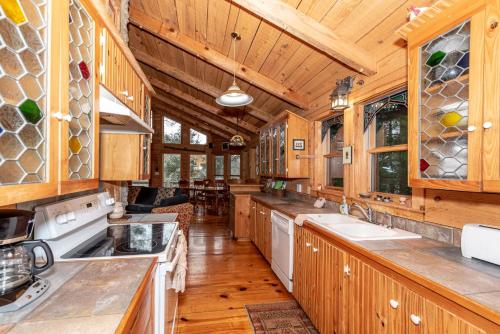 a kitchen with wooden cabinets and wooden floors and ceilings at Hayloft in Townsend