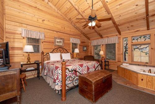 a bedroom with a bed and a tub in a cabin at Hayloft in Townsend