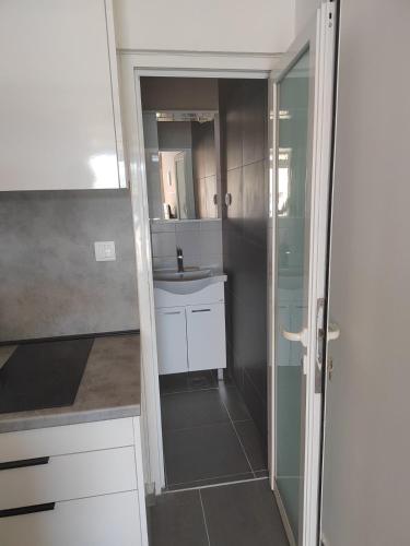 a small bathroom with a sink and a mirror at Apartments Lukrecia in Neum