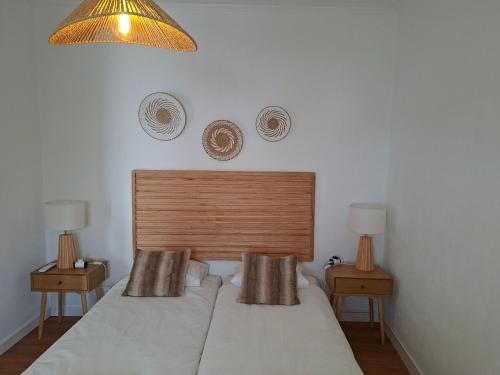 a bed in a bedroom with two nightstands and two lamps at Casa D Alma in Aljustrel