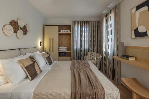 a bedroom with a large bed and a chair at Annas's Main Street Apartment in Skala