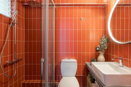 a bathroom with a shower and a toilet and a sink at Annas's Main Street Apartment in Skala
