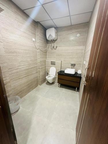 a bathroom with a toilet and a sink at The Urban Villa in Noida
