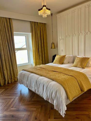 a bedroom with two beds and a window at The Old Parish Office! in Midleton