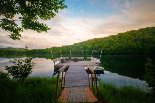 a dock on a body of water with a boat at Château Morritt in Mont-Tremblant