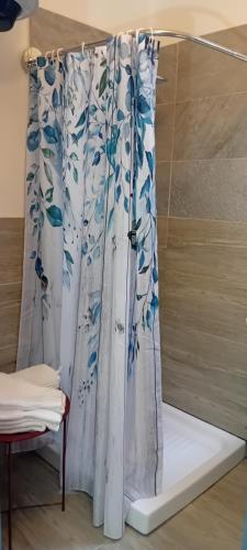 a shower curtain in a room with a bed at La Collina dei Conigli - immersi nella natura in Castellarano