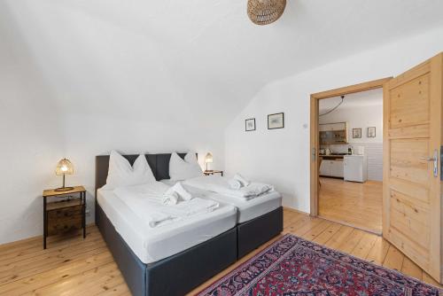 a bedroom with a large bed and a bathroom at Alter Brotladen - Melk Center in Melk