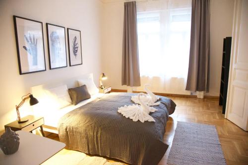 a bedroom with a bed with a white bird on it at Five Season's Apartment in Budapest