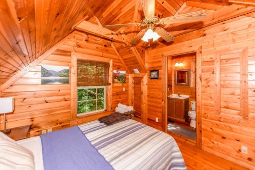 a bedroom with a bed in a log cabin at Serenity in Townsend