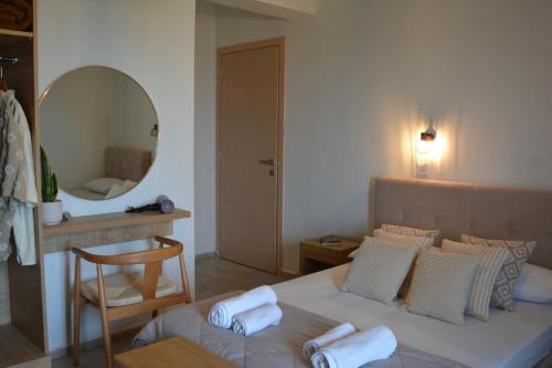 a bedroom with a bed with towels on it at Venetia in Tsoutsouros