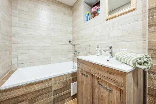 a bathroom with a sink and a bath tub at Squirrel cottage Chata Veverica in Dolná Lehota