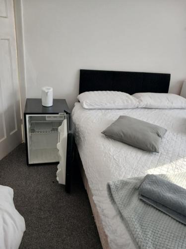 a bedroom with a bed and a nightstand with a pillow at Zoran home 3 in Leicester