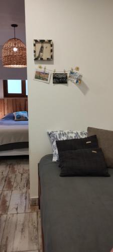 a bedroom with a bed and some pictures on the wall at Casa cronopio in Ushuaia