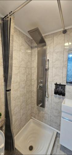 a bath tub in a bathroom with a shower at Alma-Libre house 2 in Kefalos