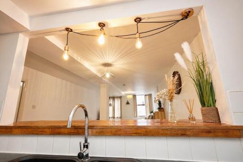a mirror above a kitchen sink in a kitchen at The MCR Prime Pad in Manchester