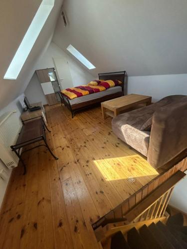 a attic room with two beds and wooden floors at Sonnennest am Stadtrand in Schwerin