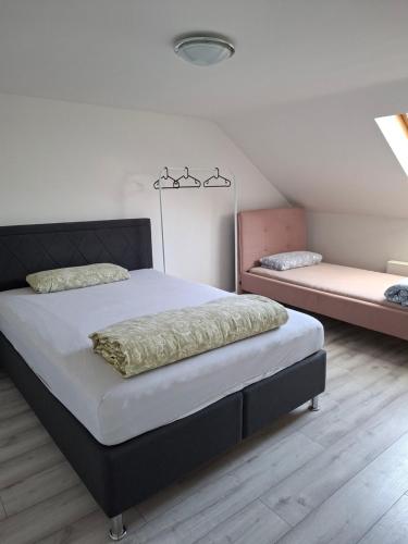 a bedroom with a large bed and a couch at Pension Rückert in Kassel