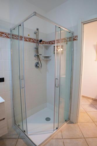 a shower with a glass enclosure in a bathroom at L'Appartamentino in Casa Donato