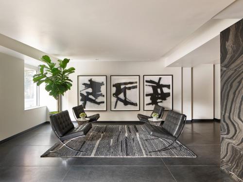 a living room with three chairs and a rug at AKA Rittenhouse Square in Philadelphia