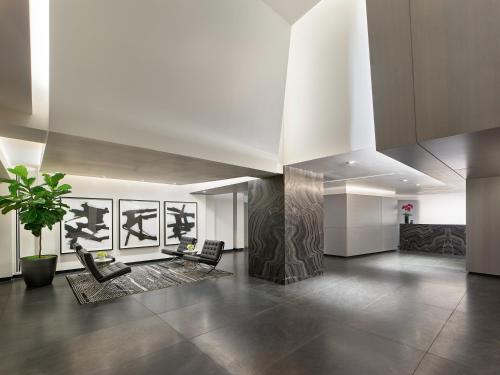a lobby with chairs and a potted plant at AKA Rittenhouse Square in Philadelphia